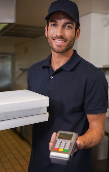 Pizza delivery man handing over a PDQ terminal pizza delivery man holding a PDQ terminal