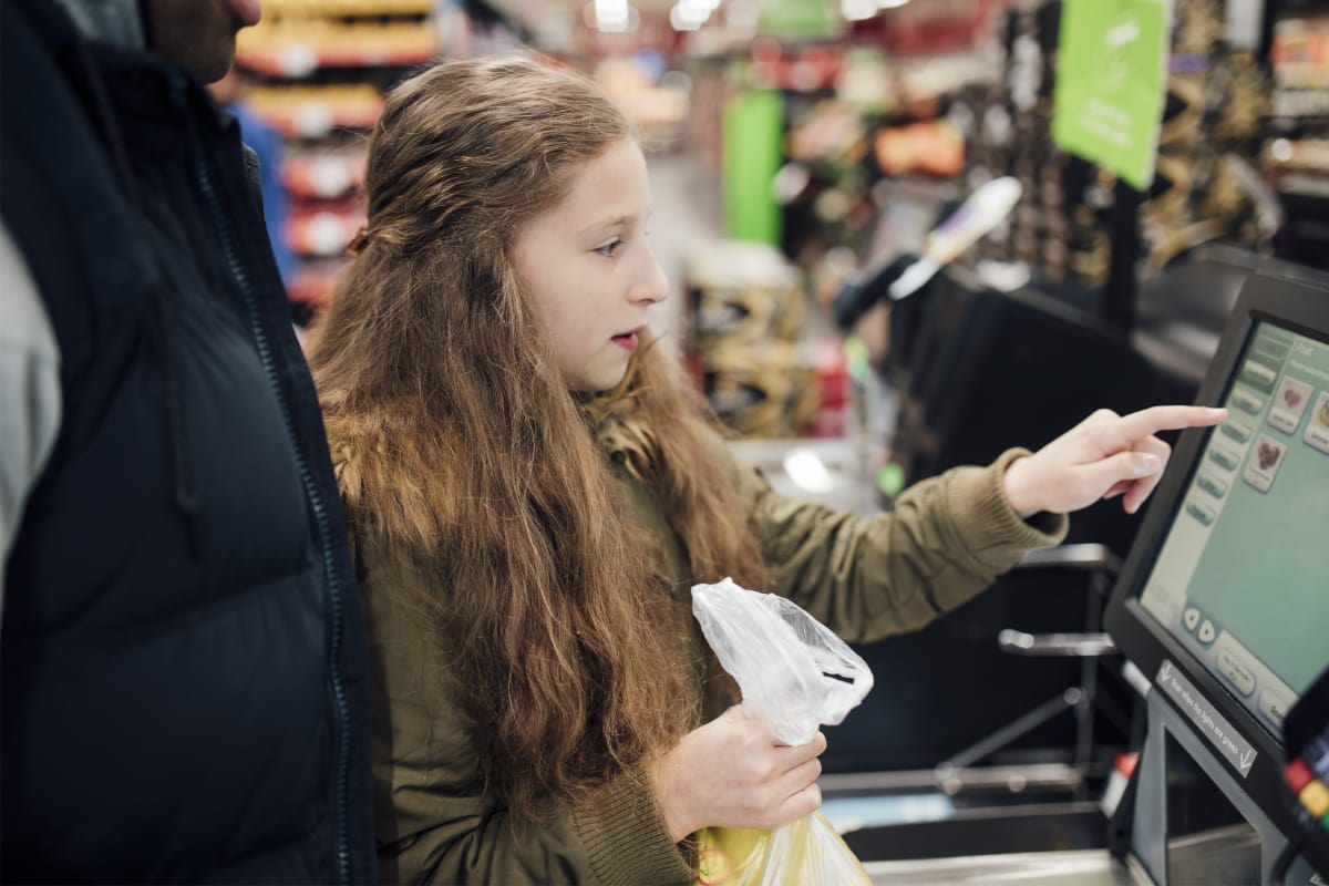 Self-service checkout at a supermarket girl at a supermarket self-service checkout