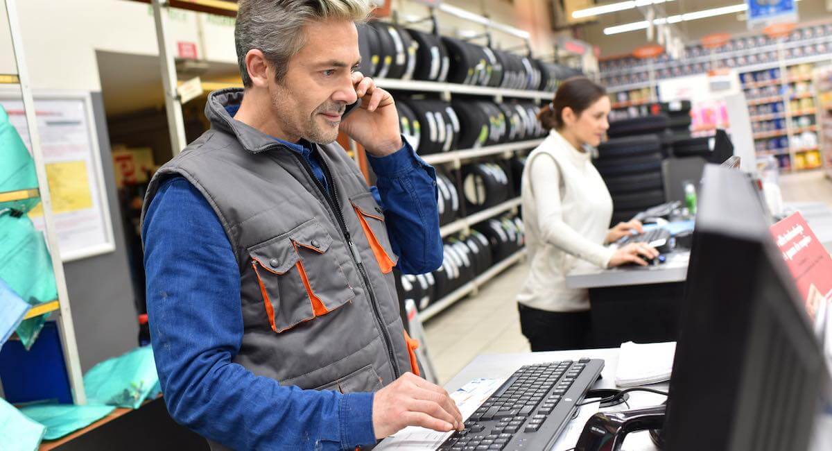 Shop worker accepting payment over the phone shop worker accepting payment over the phone