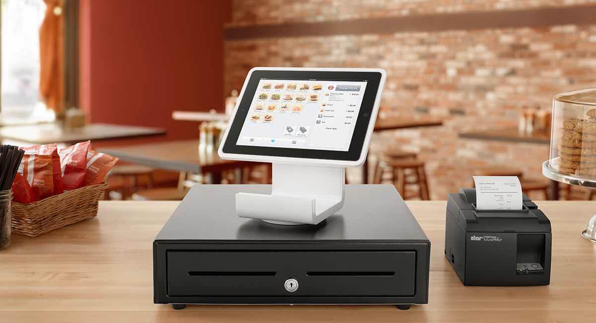 Square Stand on cash drawer on wooden countertop Square Stand on cash drawer on wooden countertop