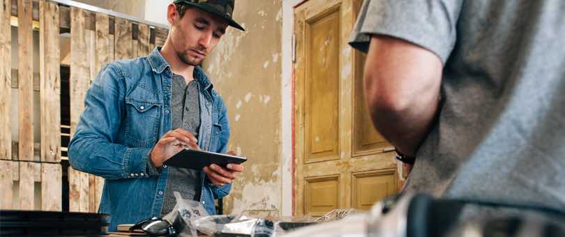 Man entering a payment on a tablet man entering a payment on a tablet