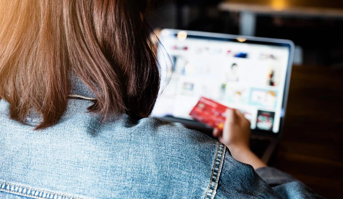 Girl paying online by card girl from behind paying online by card