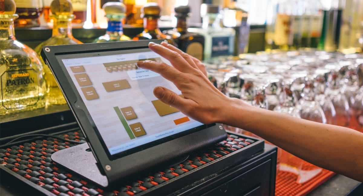 TouchBistro tablet screen behind a bar counter TouchBistro tablet screen behind a bar counter