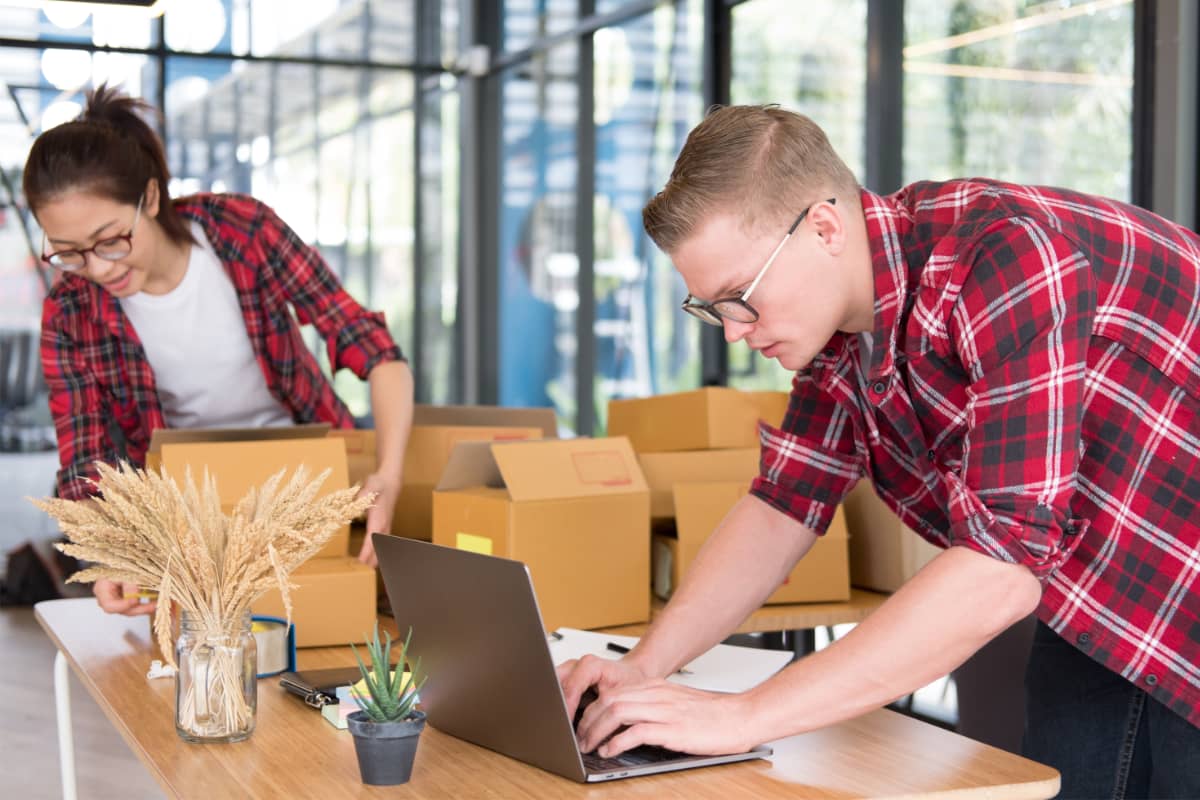 Entrepreneurs packing parcels to send to customers two entrepreneurs packing parcels to send to customers