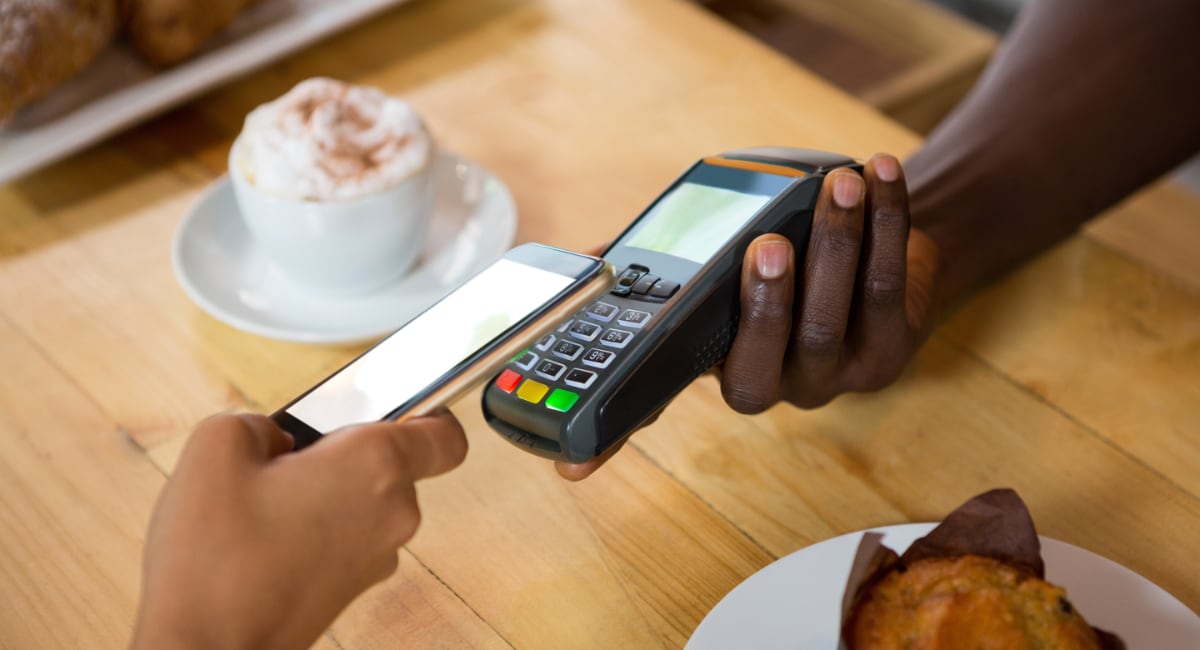 Mobile payment on Ingenico terminal in a cafe Mobile payment on Ingenico terminal in a cafe