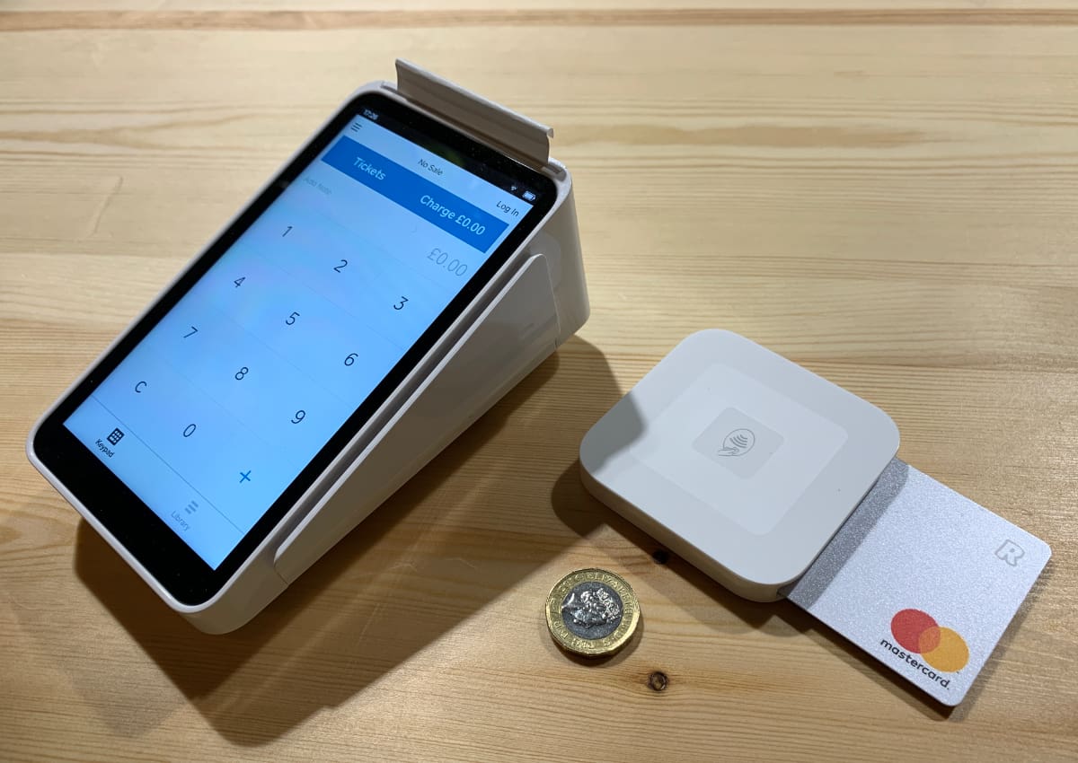 Square Terminal and Reader are both portable Square Terminal and Square Reader next to coin