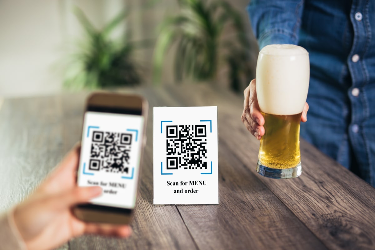 Mobile ordering through a QR code menu smartphone scanning QR code to view drinks menu