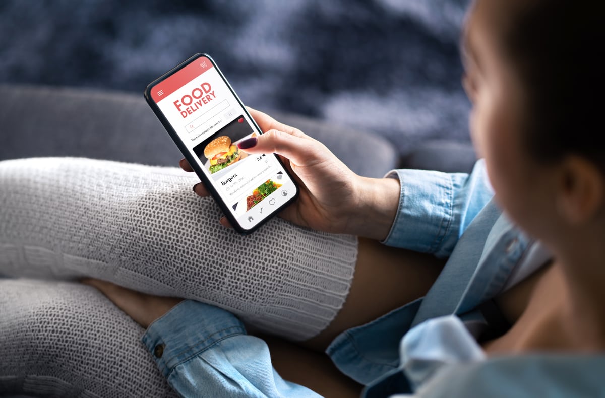 Ordering takeaway online through a food delivery app person ordering takeaway in an app