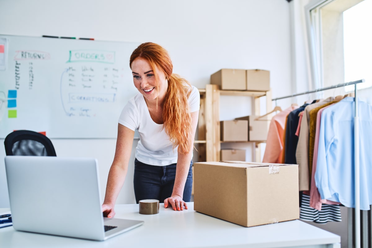 Online order being prepped for shipping woman packing an order for shipping