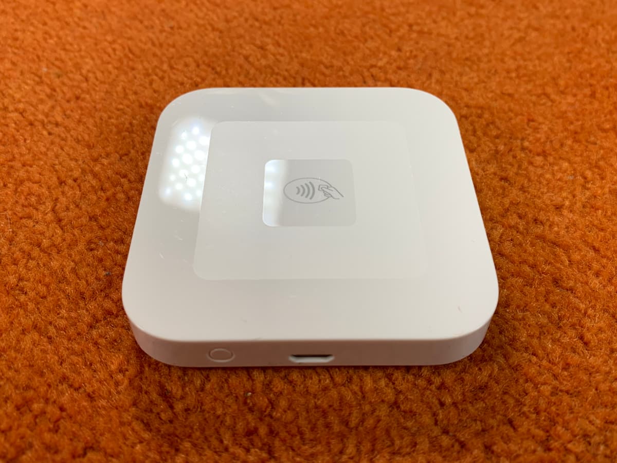 Square Reader for contactless payments Square Reader on orange carpet