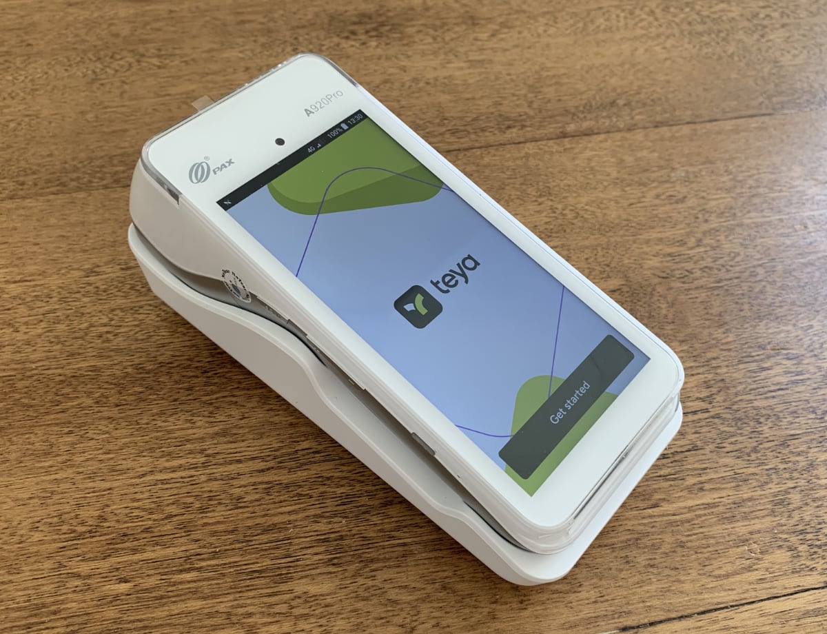 Teya’s card machine is a PAX A920Pro model Teya card machine in a desktop holder
