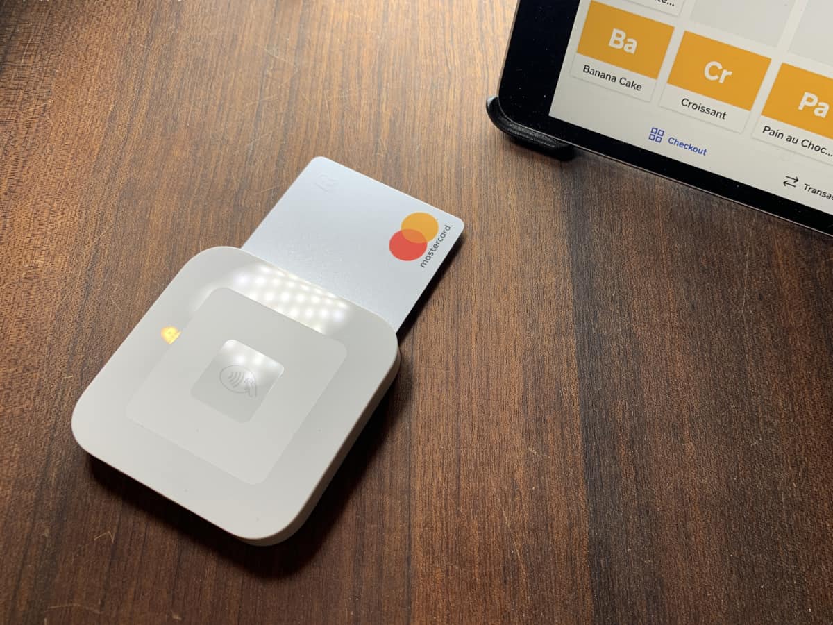 Square Reader connects wirelessly with a Square POS app on a mobile device Square Reader accepting a chip card next to corner of an iPad
